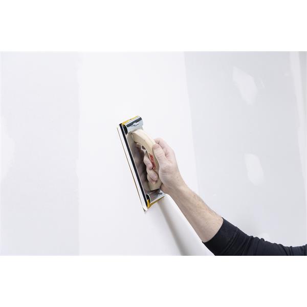 Person using a MARSHALLTOWN hand sander on a wall surface