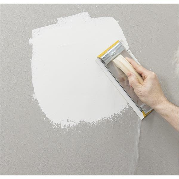 Person using a MARSHALLTOWN hand sander on a wall surface