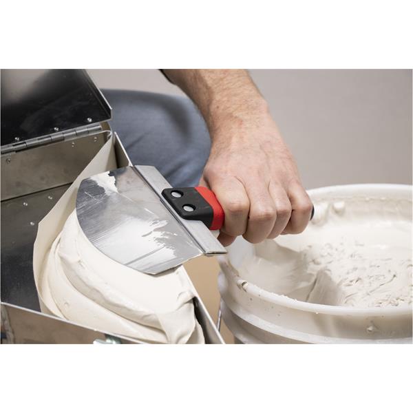 Person using MARSHALLTOWN bucket scoop to transfer material from a container