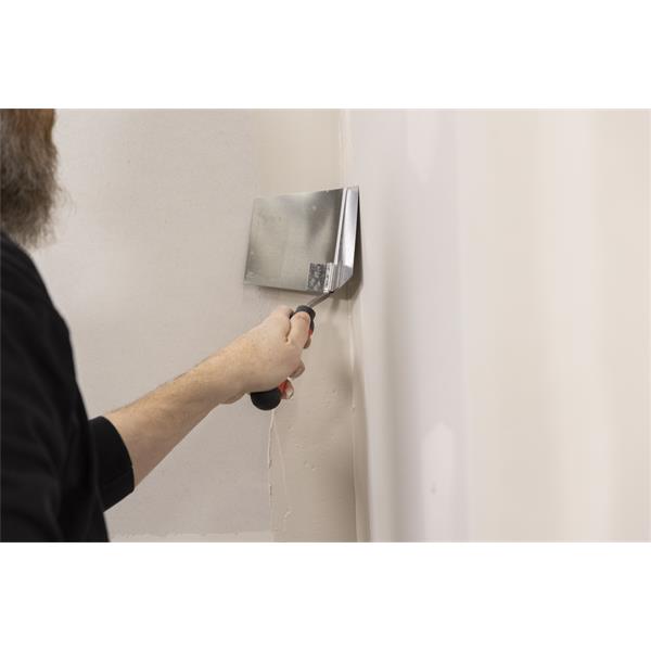 Person using WAL-BOARD TOOLS corner tool with soft grip handle on wall joint