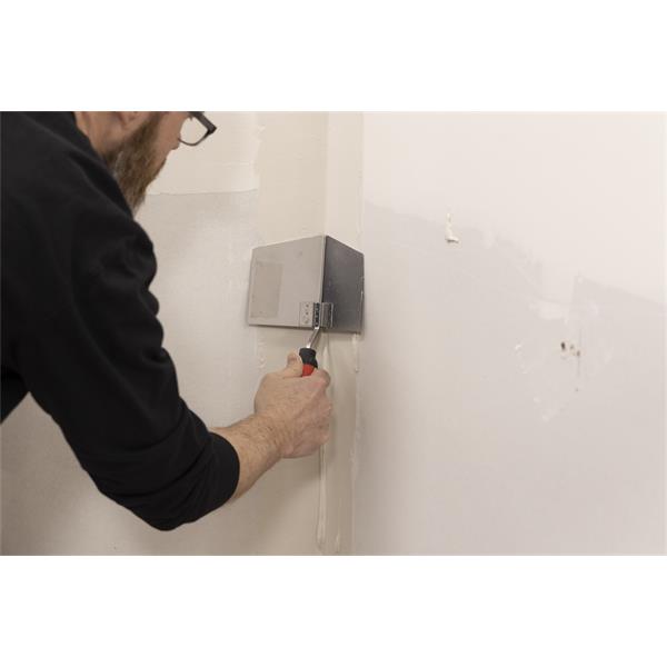 Person using WAL-BOARD TOOLS corner tool with soft grip handle on a wall corner