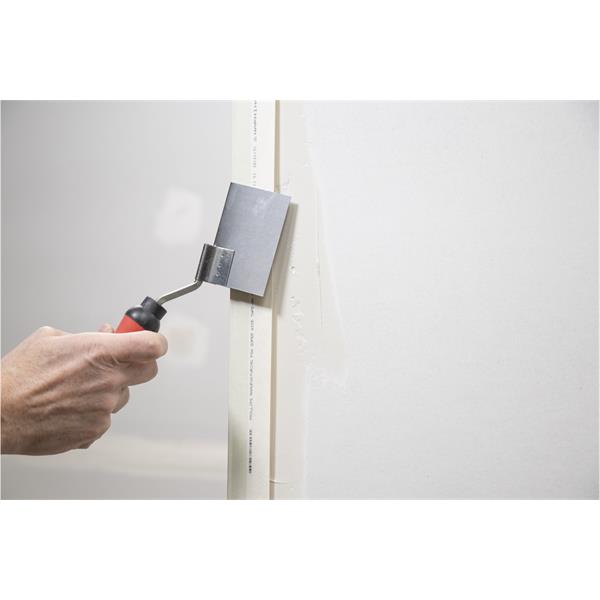 Person using WAL-BOARD TOOLS corner tool with soft grip handle on drywall angle