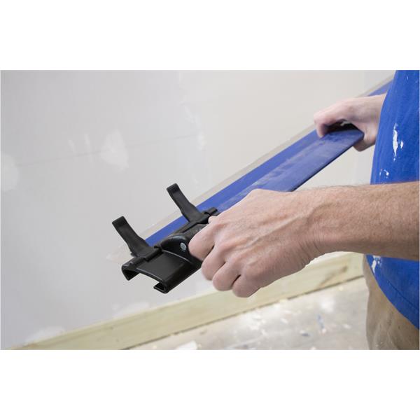 Person using a MARSHALLTOWN ProSkim™ handle bracket during wall smoothing