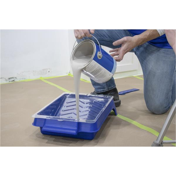 Pouring paint into a MARSHALLTOWN heavy-duty paint tray in use