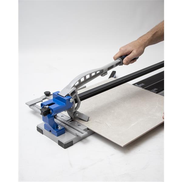 Hand using a MARSHALLTOWN 36" tile cutter to slice a tile