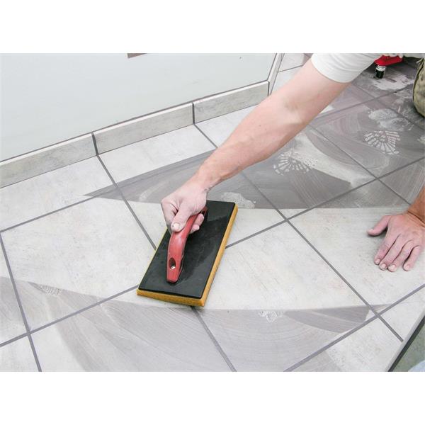 Person using MARSHALLTOWN QLT Grout System on tiled floor