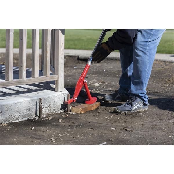 Person using a MARSHALLTOWN QLT Stake Puller at a construction site