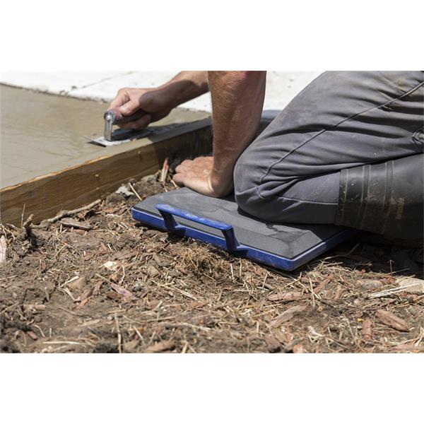 Person using a MARSHALLTOWN kneeler board while working on concrete.