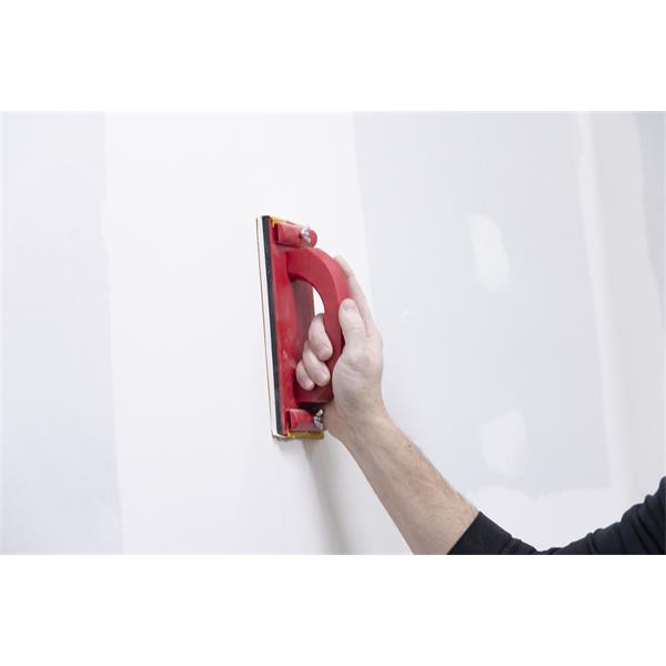 Person using a MARSHALLTOWN hand sander on a wall