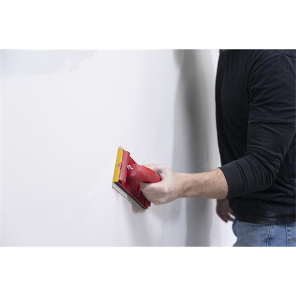 Person using a MARSHALLTOWN hand sander on a wall surface