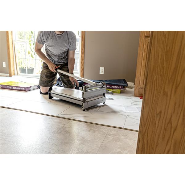 Person using a BULLET TOOLS Marksman EZ Shear to trim flooring tiles