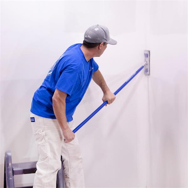 Person using MARSHALLTOWN pole sander handle on a wall