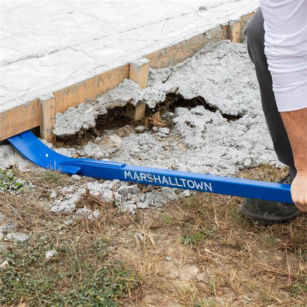 Person using a MARSHALLTOWN Little Monster Pry Bar to lift concrete slab