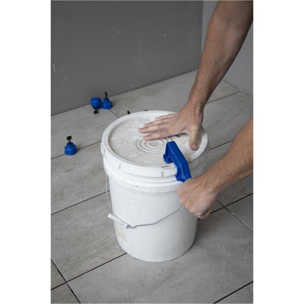 Hands using a MARSHALLTOWN bucket opener on a sealed container lid