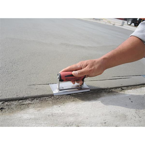 Person smoothing concrete with MARSHALLTOWN curb outside tool