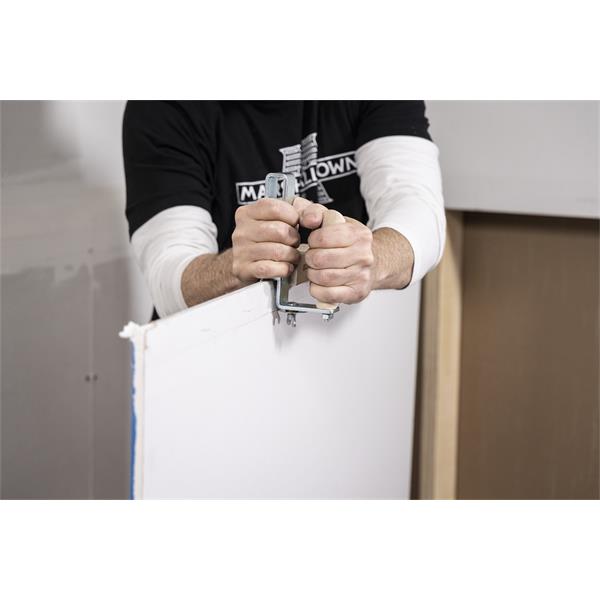 Person using a MARSHALLTOWN drywall stripper on a panel.