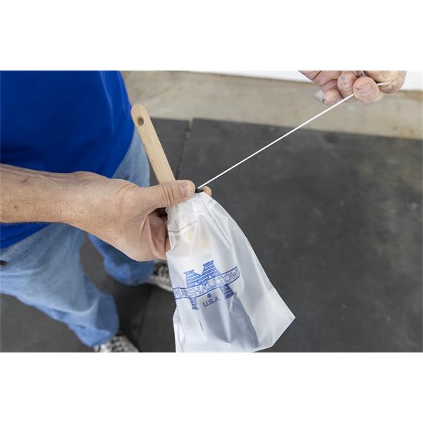 Person preparing MARSHALLTOWN Paint Brush Saver for storage