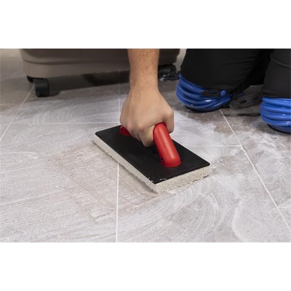 Person using BARWALT Ultra Grouting System on tile flooring